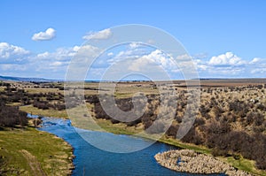 Picturesque autumn landscape of river and blue sky