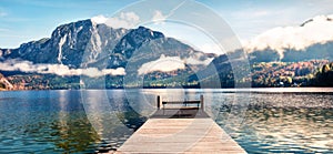 Picturesque autumn scene of Altausseer See lake Trisselwand peak on background. Bright morning panorama of Altaussee village,