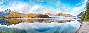 Picturesque autumn scene of sunny morning on Almsee lake. Poppular travell destination