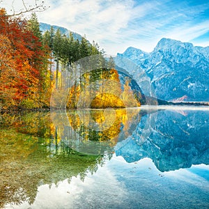 Picturesque autumn scene of sunny morning on Almsee lake. Poppular travell destination