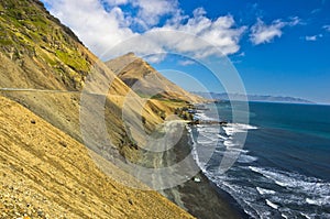 Picturesque black sand volcanic beach at summer, south Iceland