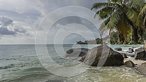 Picturesque boulders lie in the water near the ocean shore.