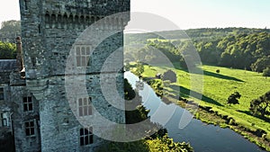 A picturesque castle against the landscape. River and lawn in front of Lismore Castle tower