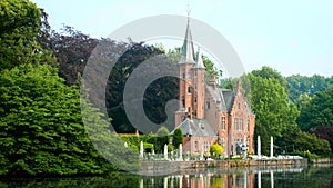 Picturesque castle in Minnewater Park, Bruges, Belgium