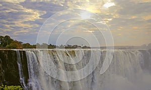 Picturesque celestial landscape with the rays of the morning sun over Victoria Falls