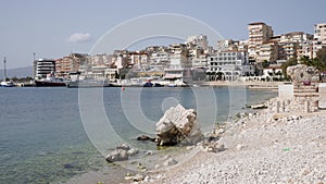Picturesque cityscape of Albanian city of Sarande on coast of Ionian Sea overlooking modern residential area with houses