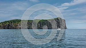 The picturesque coast of Kamchatka against the blue sky.