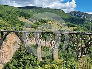 Picturesque Djurdzhevich Bridge. Montenegro. Reinforced concrete arch bridge over the Tara river. Mountains