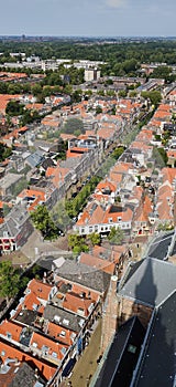 Picturesque dutch street aerial view with cathedral shadow sand brick walk way.
