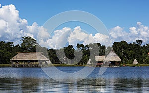 Picturesque and exotic lagoon with clean water El Milagro, loggon milagros with wooden house and thatched roof stilt houses Amazon