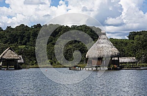 Picturesque and exotic lagoon with clean water El Milagro, loggon milagros with wooden house and thatched roof stilt houses Amazon