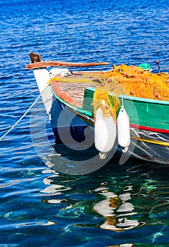 Picturesque fishing boat in a harbor before sunset