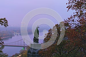 Picturesque foggy landscape of morning Kyiv in the Saint Volodymyr Hill. View of Saint Volodymyr monument and Dnipro River.