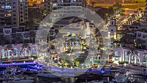 Picturesque fountain on Dubai Marina promenade aerial all night timelapse
