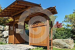 Picturesque fragments of gate above path leading to Tea House in Japanese Garden. Public landscape park of Krasnodar