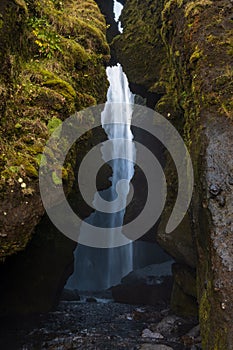 Picturesque Gljufrabui waterfall in the stone cavern autumn view, southwest Iceland