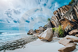 Picturesque granite boulders formation on tropical white sand beach Grand Anse, La Digue island, Seychelles