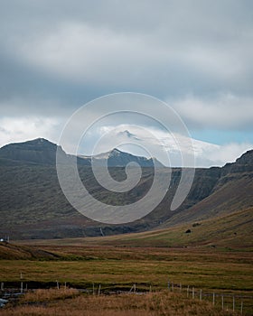 Picturesque grassland valley and valley wall under a cloudy sky