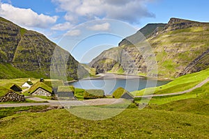 Picturesque green landscape with black houses in Faroe islands. Saksun