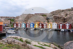 Picturesque harbor with colorful boats and buildings in Munkkyrkan, Smoegen, Sweden