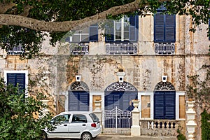 Picturesque house in Mdina, Malta, with navy blue door and windows shutters