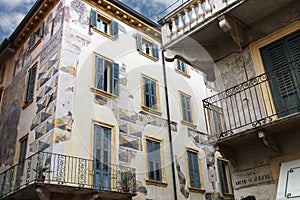 The picturesque house with murals on the street via Arche Scaligere in Verona, Italy