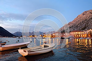 Picturesque Kotor bay at blue hour. Wonderful boats on te seascape backgrond of coast of Adriatic sea