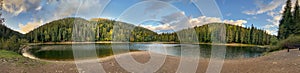 Picturesque lake in the autumn forest. Mountain Lake Synevyr in Carpathian, Ukraine. Panorama.