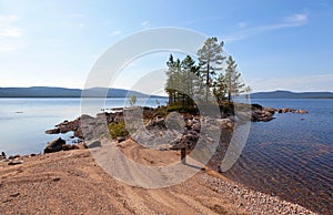 A picturesque lake with a pebble beach in the north of Russia