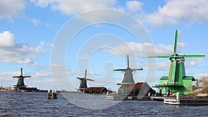 The picturesque landscape with aerial mill on the channel in Zaanse Schans, Holland on a background cloudy sky