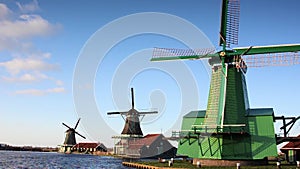 The picturesque landscape with aerial mill on the channel in Zaanse Schans, Holland on a background cloudy sky