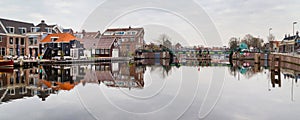 Picturesque landscape with beautiful traditional houses reflection in canal, Haarlem, Holland