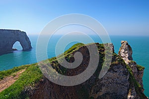 Picturesque landscape on the cliff of Etretat. la Manneporte natural rock arch wonder, cliff and beach