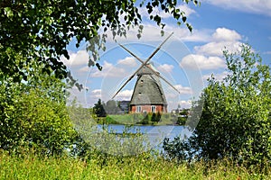 Picturesque landscape with old mill and lake