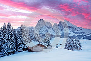 Picturesque landscape with small wooden house on meadow Alpe di Siusi
