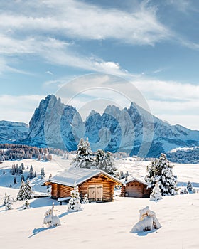 Picturesque landscape with small wooden house on meadow Alpe di Siusi