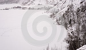 A picturesque landscape of a snow-covered quarry with skiers. Winter landscape