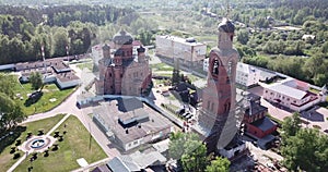 Picturesque landscape with Transfiguration Cathedral and old belfry during restoration in missionary monastery in small