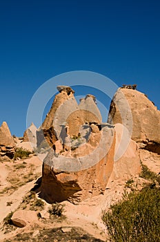 Picturesque landscape view of typical geologic formations of Cappadocia. Mountain in the sunset light in the background