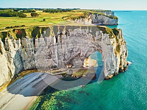 Picturesque landscape of white chalk cliffs and natural arches of Etretat, France