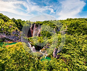 Picturesque morning csene of Plitvice National Park. Colorful spring view of green forest with pure water lake and waterfall.