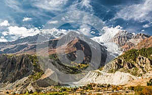 Picturesque mountain panorama. Glacier river flowing though a valley.