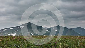 A picturesque mountain range against a cloudy sky.