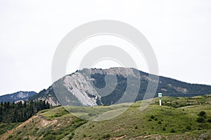 Picturesque Mountain Range In A Rural Area With A Tower On The Top photo
