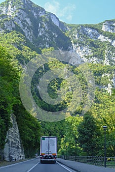 picturesque mountain road in the mountains, truck moving on the highway. Genga, Marche, Italy. The Appennines