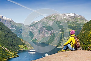 Picturesque Norway mountain landscape. Young girl enjoying the view near Geiranger fjord, Norway