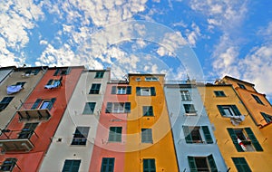 Picturesque panorama with colorful houses with windows and balcony against blue sky in Porto Venere, Italy, Liguria