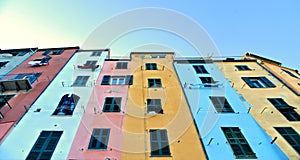 Picturesque panorama with colorful houses with windows and balcony against blue sky in Porto Venere, Italy, Liguria