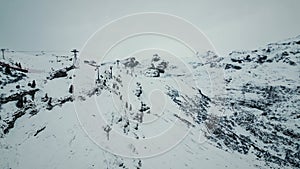 Picturesque panorama of snowy rocky Titlis mountain in Engelberg with cable car