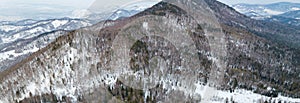 Picturesque panoramic landscape in the Altai mountains with snow-capped peaks under a blue sky with clouds in winter. White snow